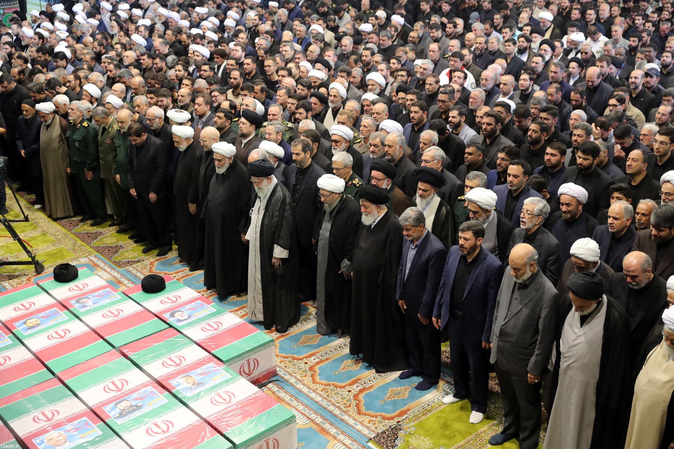 Tehran (Iran(islamic Republic Of)), 21/05/2024.- A handout picture made available by the Iranian supreme leader office shows, Iranian supreme leader Ayatollah Ali Khamenei praying over the coffins of late president Ebrahim Raisi and the rest of the victims during a funeral ceremony in Tehran, Iran, 22 May 2024. Iranian president Raisi and seven others, among them foreign minister Amir-Abdollahian, were killed in a helicopter crash on 19 May 2024, after an official visit in Iran
